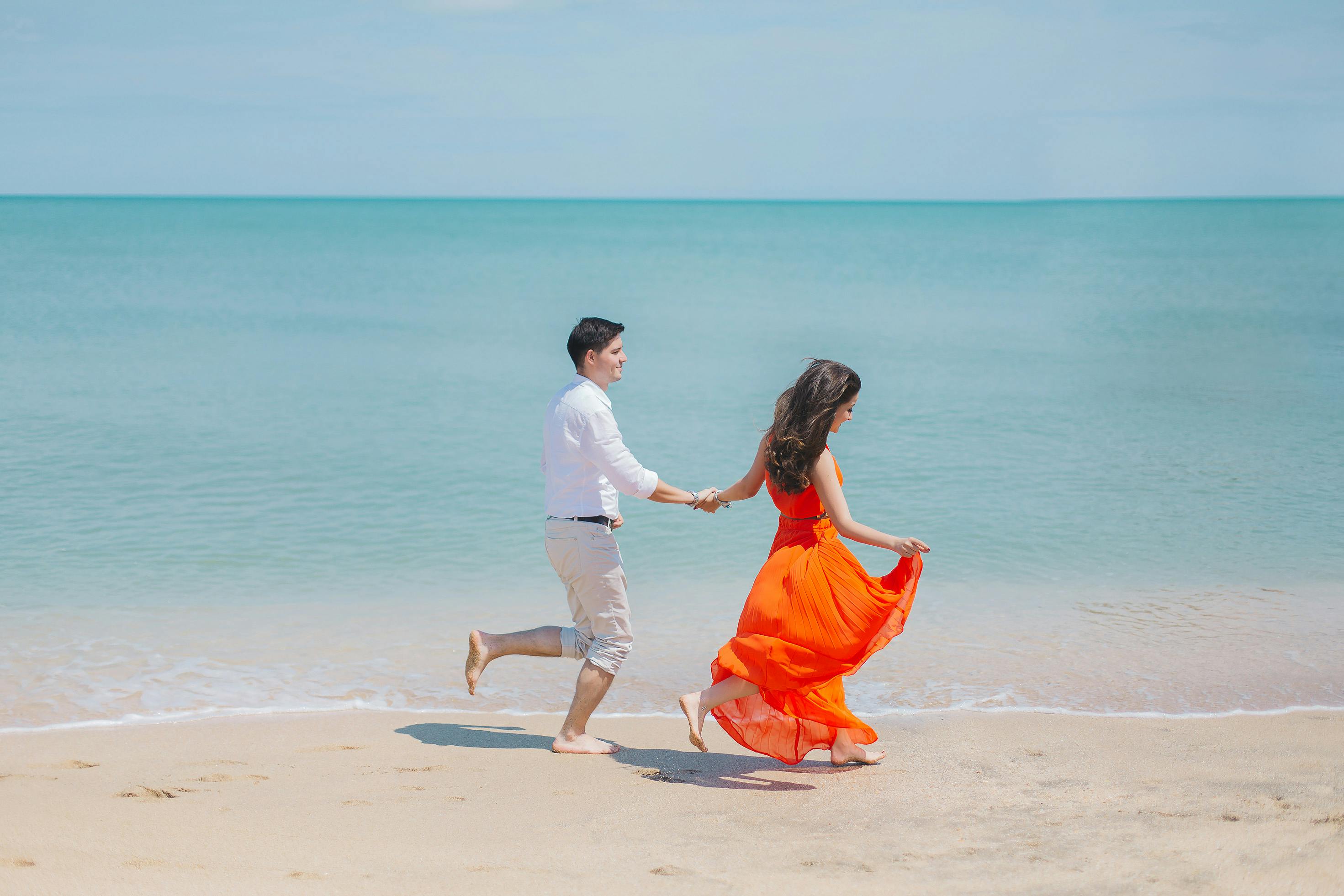 Couple running together on the beach